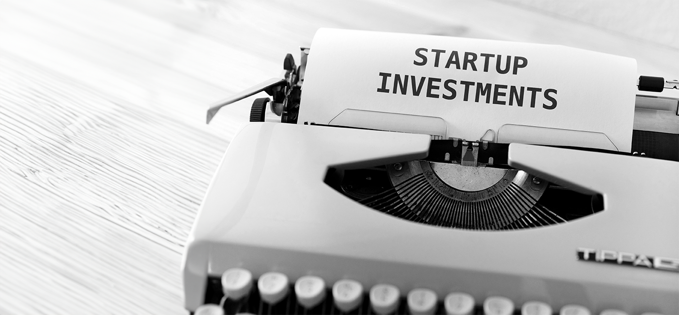 a black and white photograph of a typewriter with a page saying 'startup investments'.